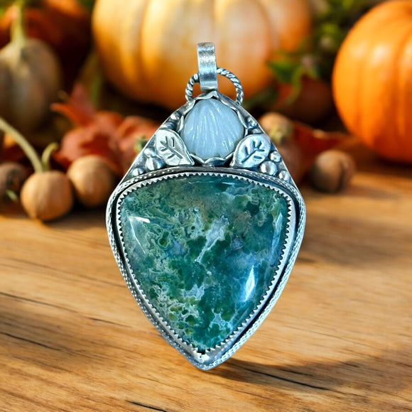 Indonesian Plume Agate and carved Moonstone sterling silver pendant.  $75