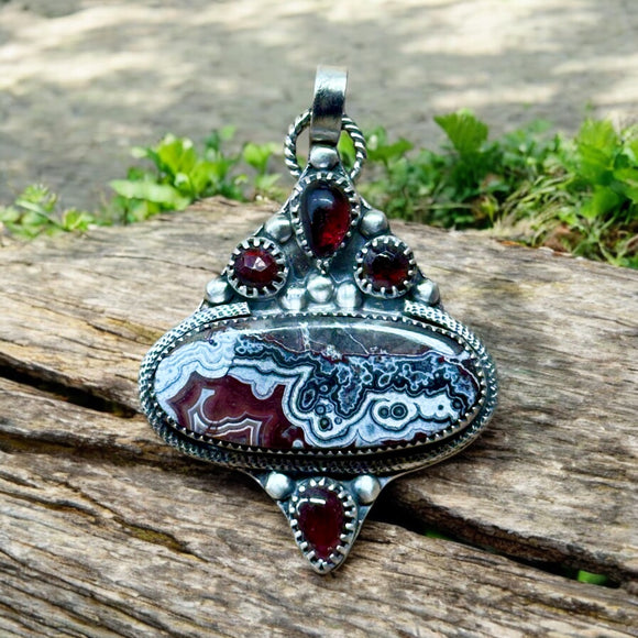 Crazy Lace Agate and Garnet sterling silver pendant.   $70