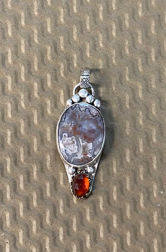 Crazy Lace Agate and Garnet sterling silver pendant.     $60
